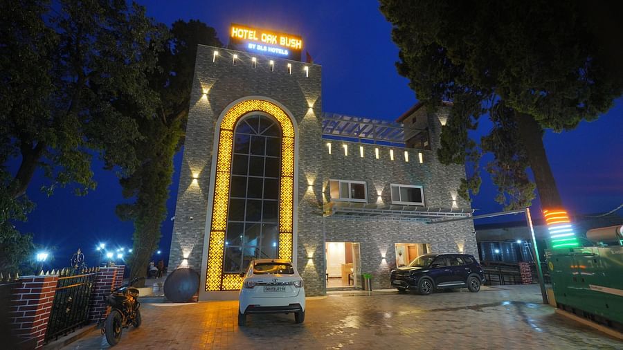 Facade view at night of DLS Oak Bush, Mussoorie with car parked outside.