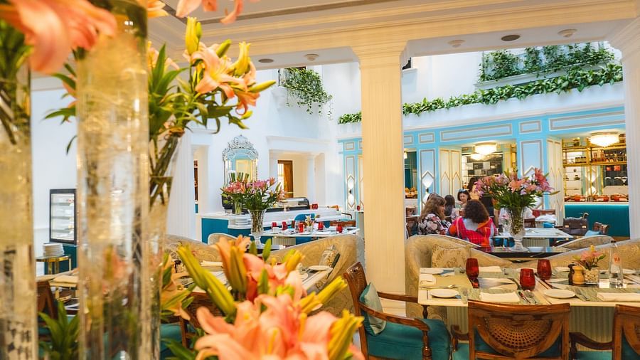 A picturesque restaurant setting with floral decor and outdoor seating