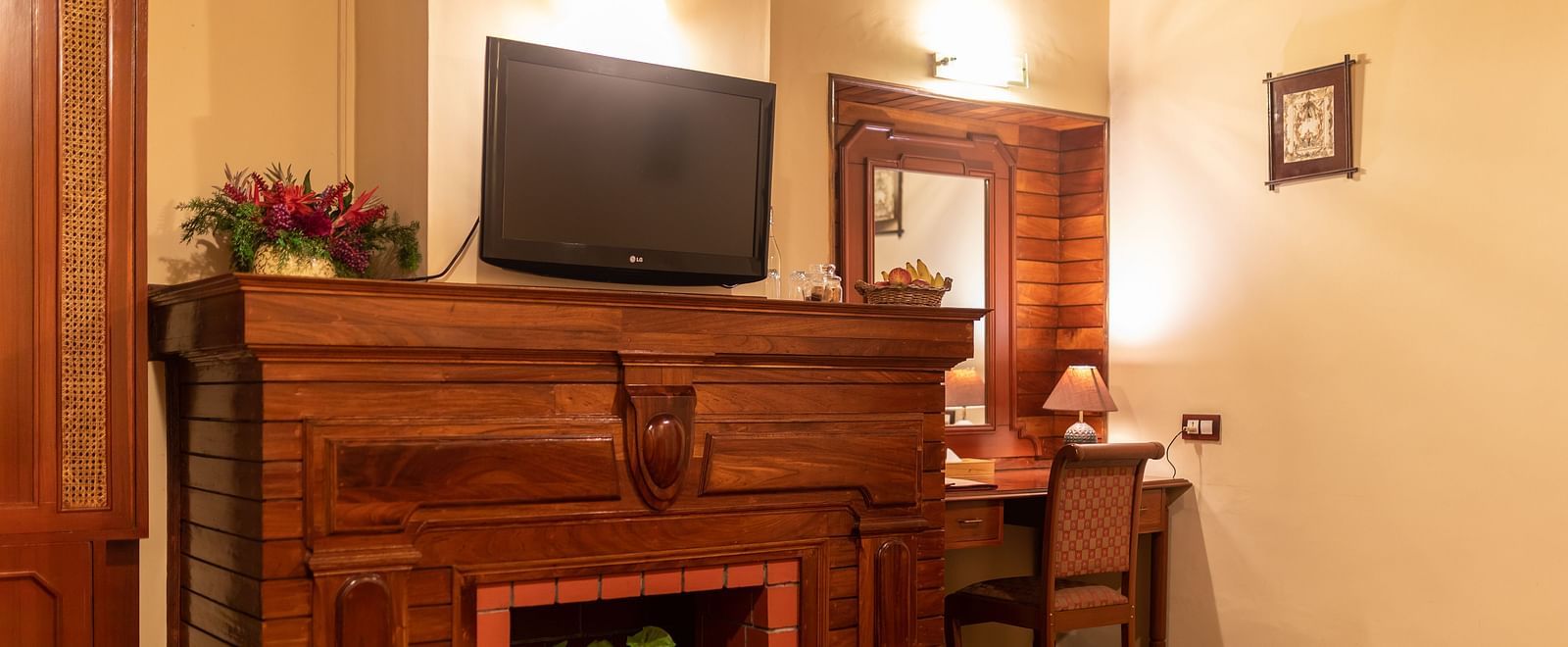 Comfortable room with a fireplace, greenery, and a television - BluSalzz Collection - Tranquil Resort, Wayanad