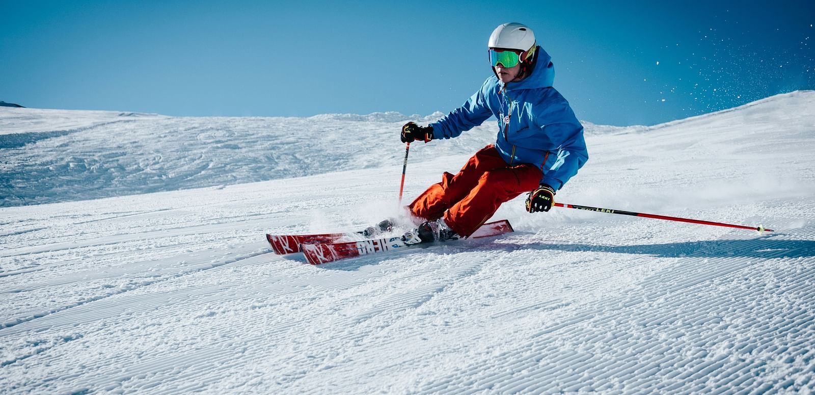A person skiing down a snow-covered slope.