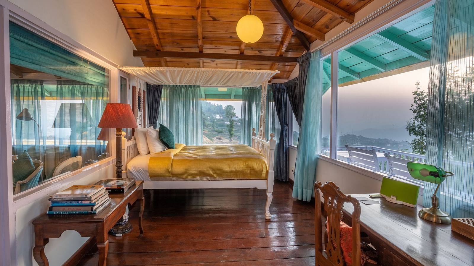 wide angle view of a room with a bed and large windows at Te Aroha By Shervani, Mukteshwar