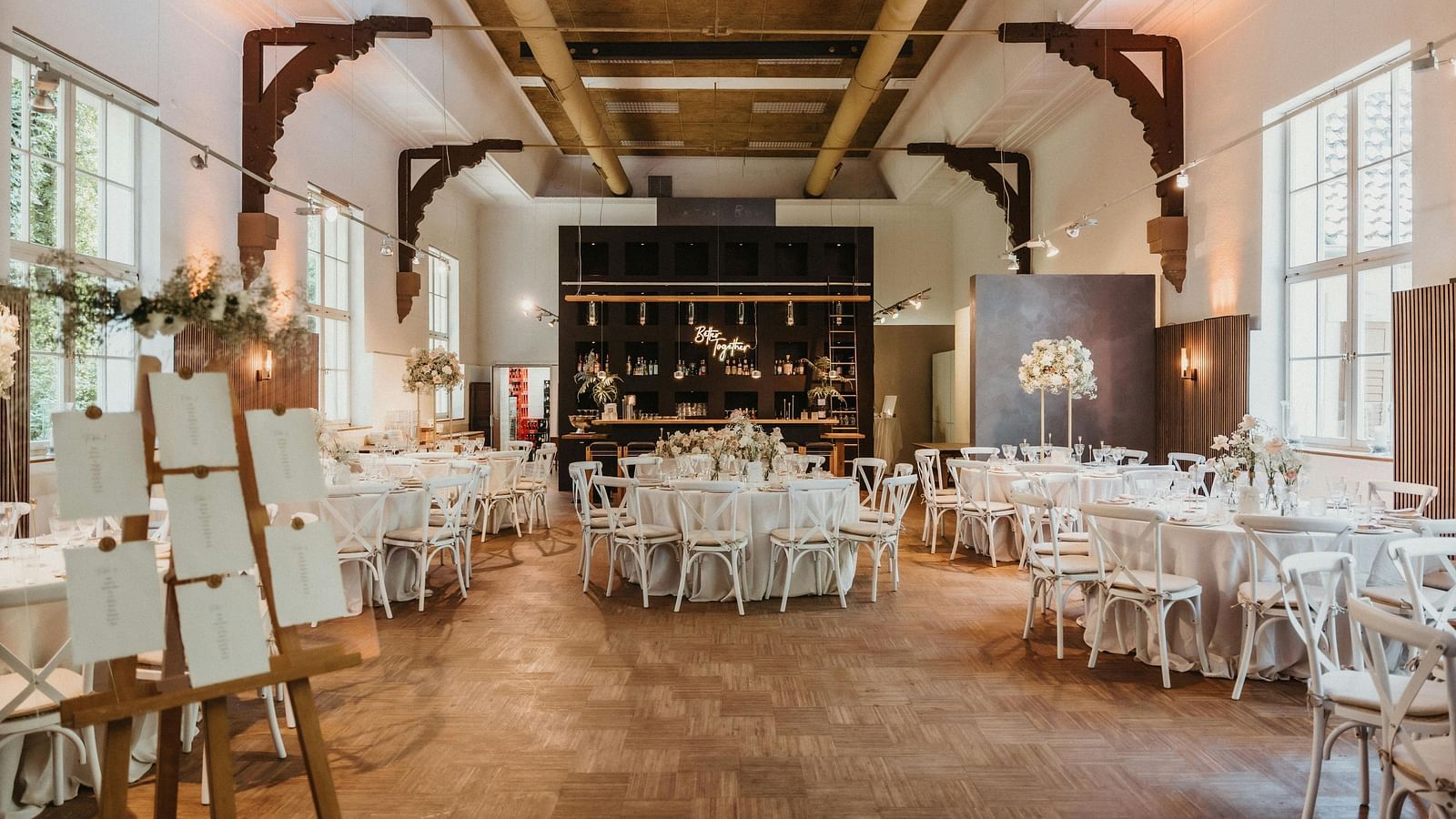 An image of a banquet hall with seating arrangement and decoration