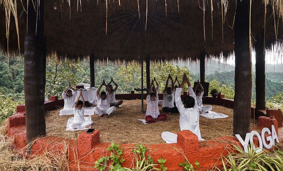 people practicing yoga inside the yoga centre - Holistic Stay Eco Resort, Kannur