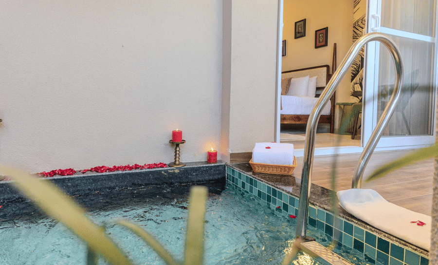 Private plunge pool decorated with rose petals and candles for a romantic setup in the Royal Suite at Hotel Bawa, Udaipur.