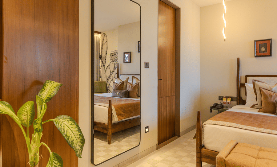 Full length mirror beside a wooden wardrobe door with warm hallway lighting in the Imperial Suite at Hotel Bawa, Udaipur.