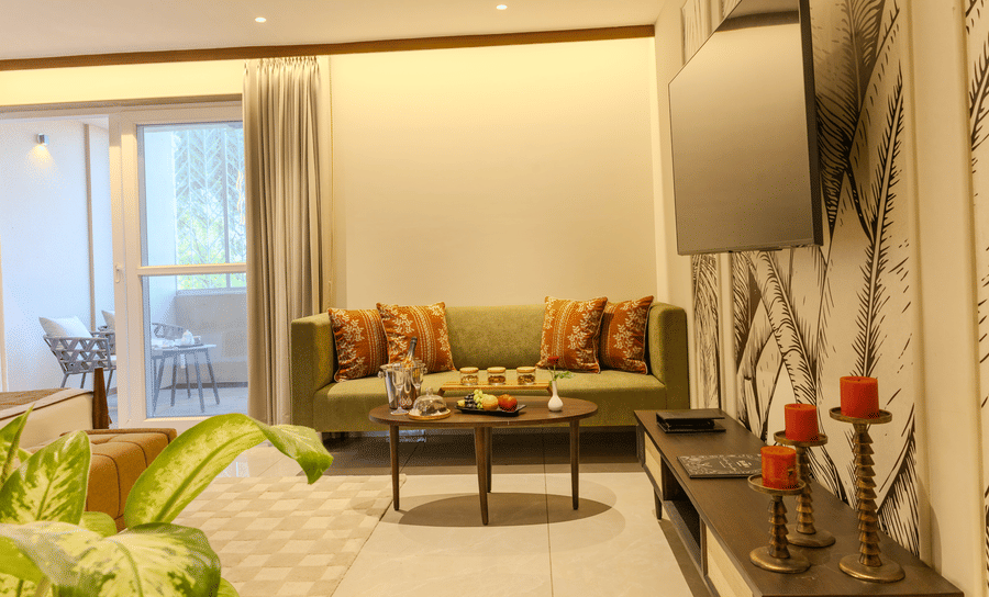 Living area with a cushioned sofa, wooden coffee table and decorative elements in the Imperial Suite at Hotel Bawa, Udaipur.