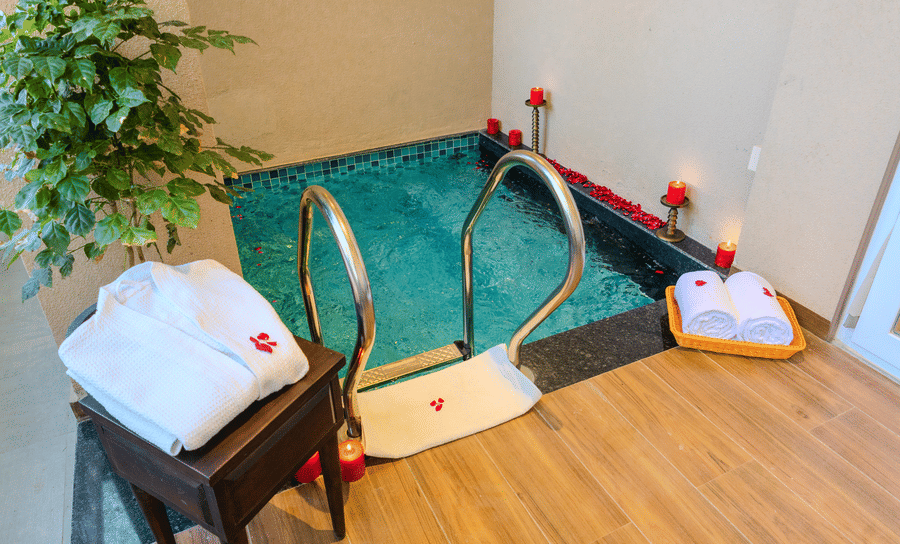 Private plunge pool decorated with rose petals and candles for a romantic setup in the Royal Suite at Hotel Bawa, Udaipur.