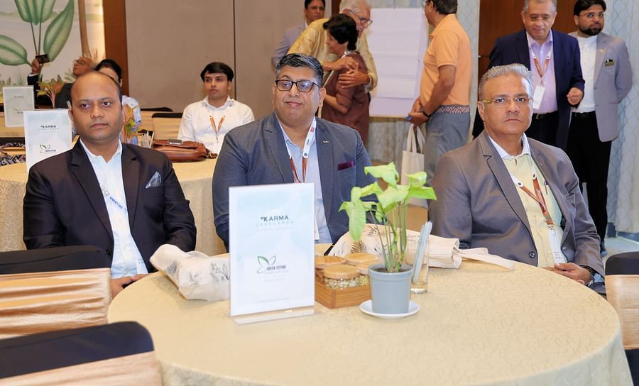 Group of people seated at a table during an event - Karma Lakelands.