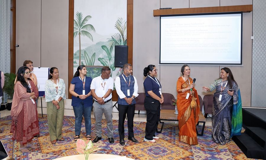 Attendees standing on stage as part of an event activity - Karma Lakelands.