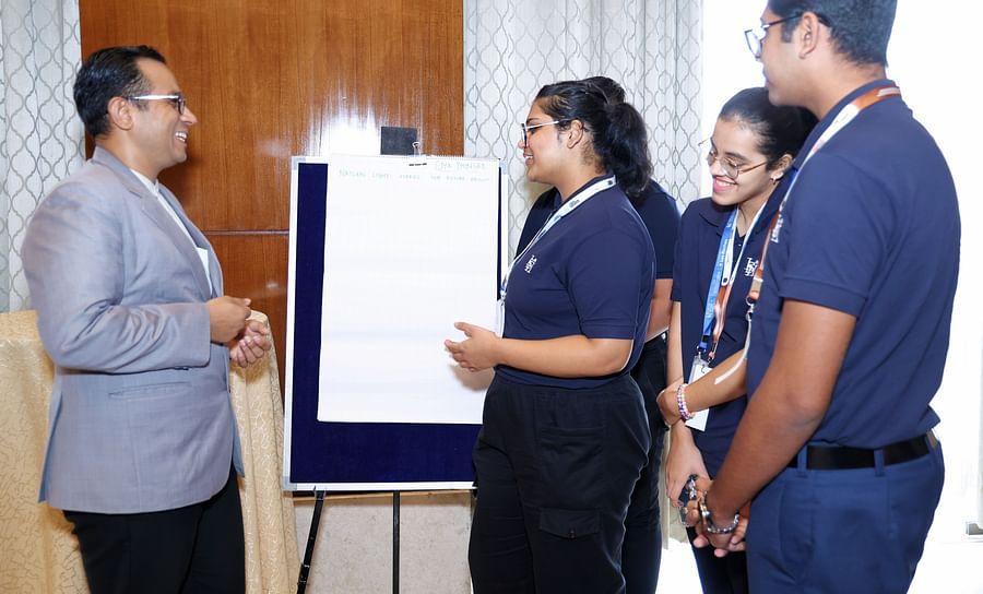 Attendees participating in a group activity with a flipchart - Karma Lakelands.