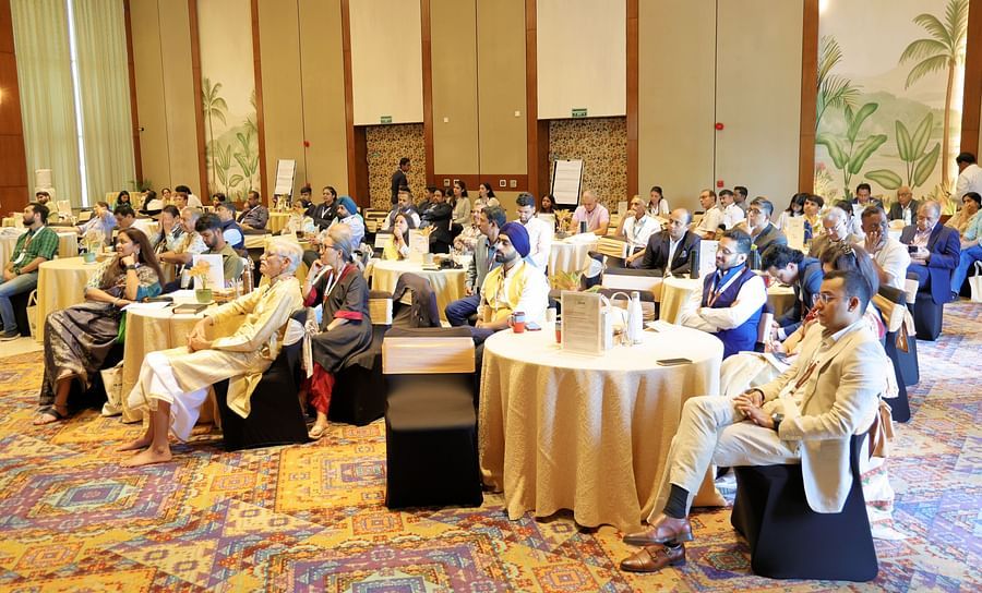 Group of participants seated at a table during a discussion - Karma Lakelands.