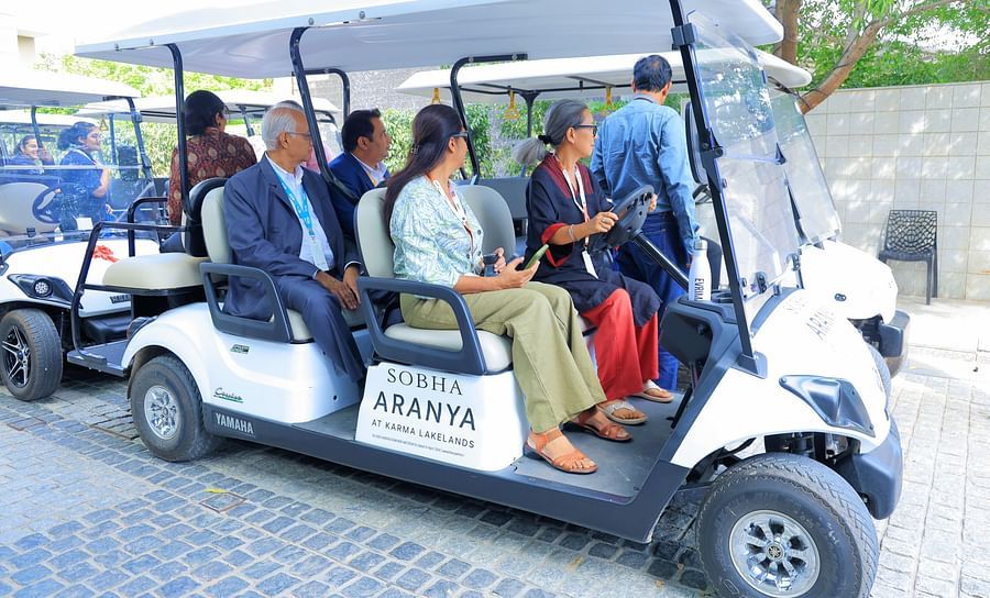 Image of a few golf cars with a few people seated in them - Karma Lakelands.