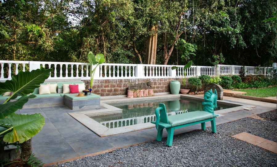 Pool  with green chair@ Lamrin Ucassaim Hotel, Goa