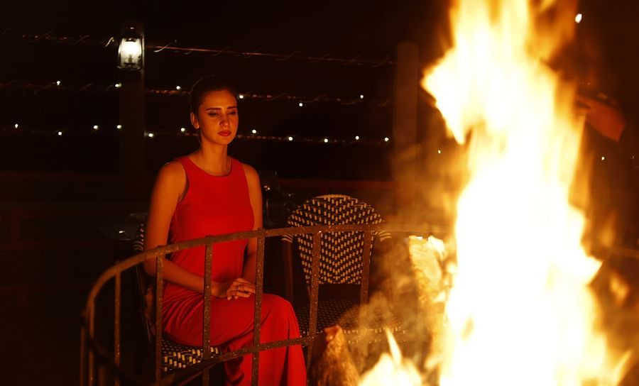 alt-text a person looking at a bonfire - Polo Orchid Resort, Cherrapunji