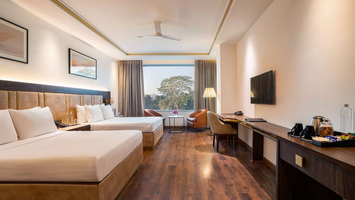 Comfortable guest room with a spacious bed and large window - Clarks Inn, Dehradun