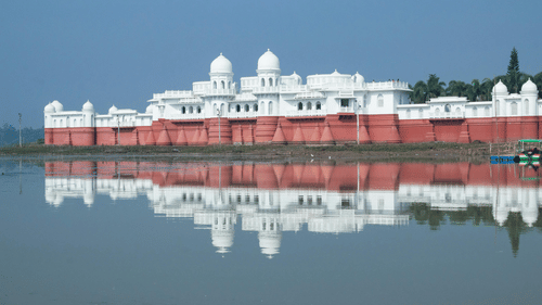 a monument behind a lake 