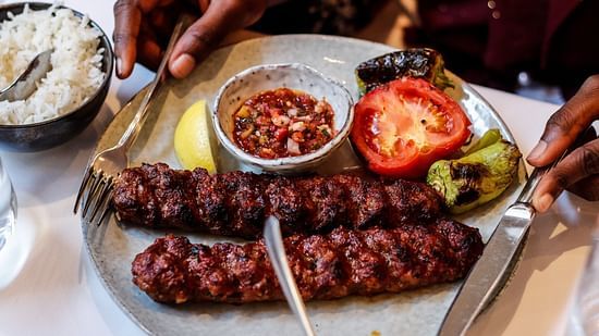 a plate of kebabs served to a diner