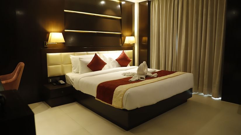 Junior Suite in warm lighting with lamps on both sides of the bed