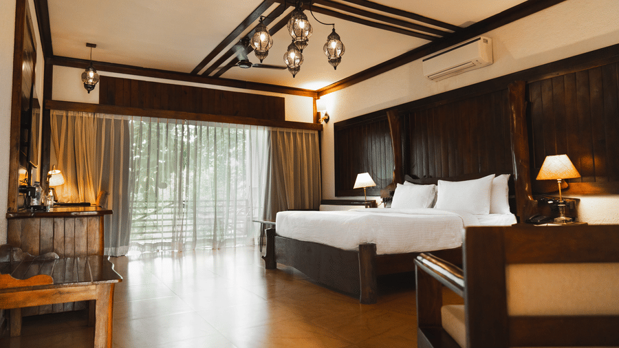 Premium Cottage Room featuring a bed, a table, and a window at Jagira Ananta Elite, Gir.