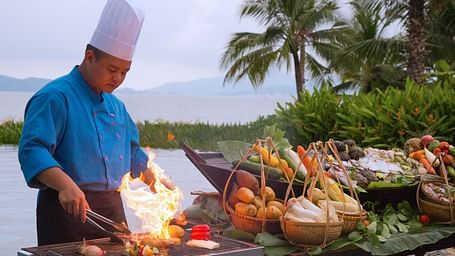 An image of a chef  roasting meet - Alibu Resort Nha Thrang