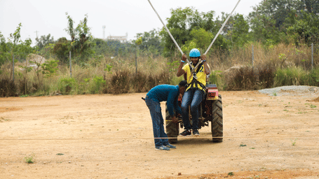 Staff members prepare a visitor for a thrilling bungee ejection experience - District Gravity Adventure Park, Hyderabad