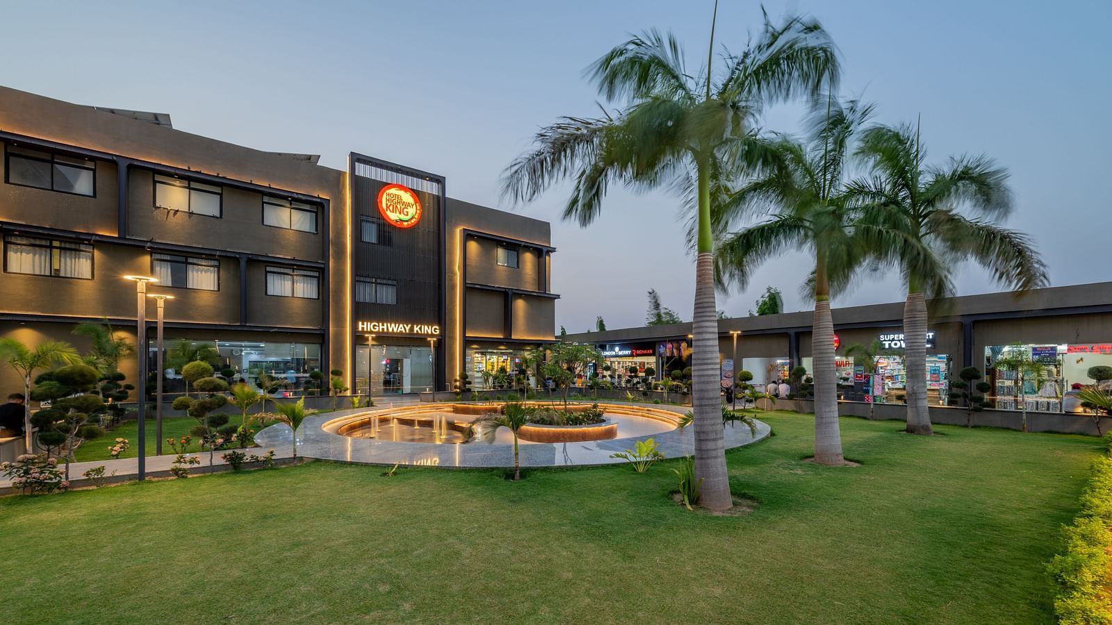 Well-manicured lawn area and a stylish walk way in front of the Hotel Highway King, Behror.