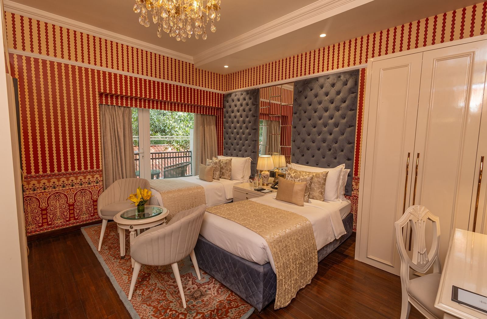 Luxury Twin Bed Room with Balcony at The Claridges New Delhi, featuring twin beds with pillows and a large window with a view