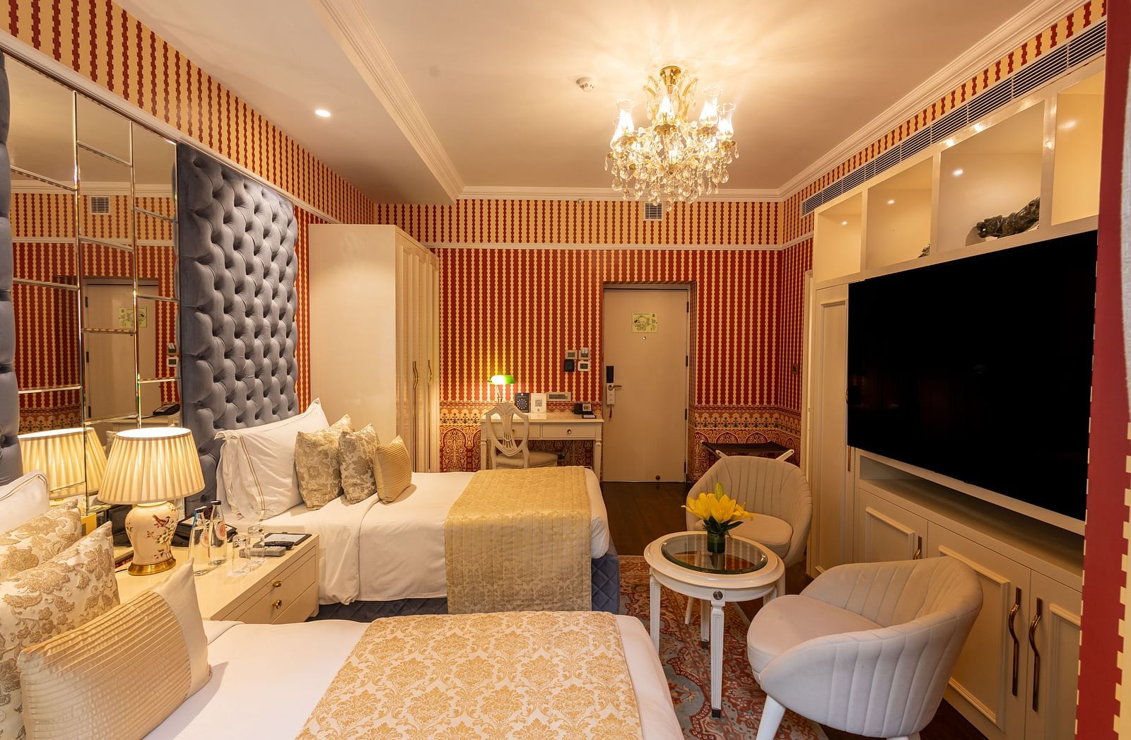 Luxury Twin Bed Room with Balcony at The Claridges New Delhi, featuring twin beds with pillows and a wall-mounted TV