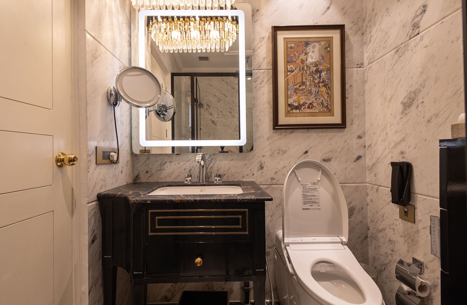 Washroom of the Luxury Twin Bed Room with Balcony at The Claridges New Delhi, featuring a modern sink and a stylish wall-mounted mirror