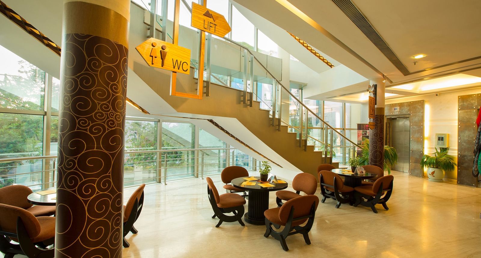 lobby of Hotel Atithi - TGI Grand, Pondicherry arrayed tables and chairs