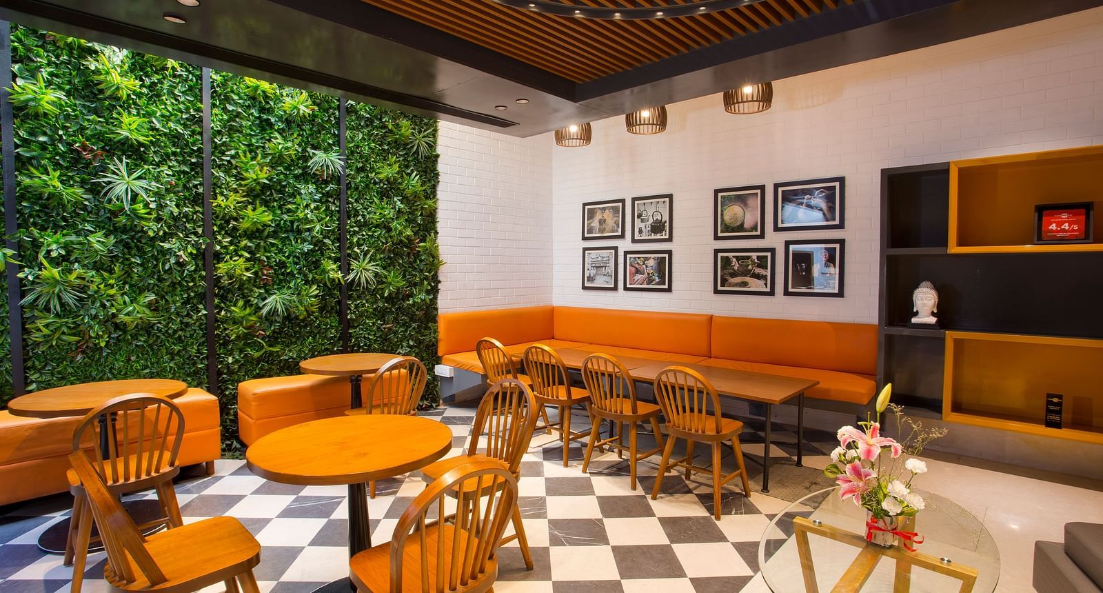 a room with large windows with views of trees and circular tables with chairs around them - Hotel Fountain Tree By TGI - JP Nagar, Bangalore