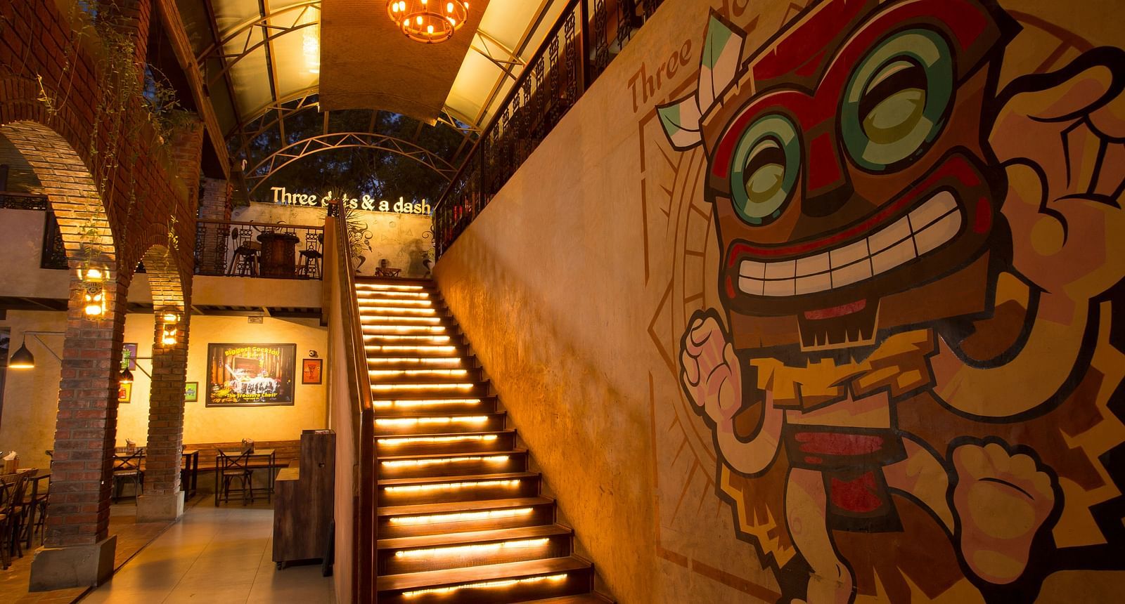 a staircase leading upstairs with graffiti on the wall beside the staircase - Hotel Fountain Tree By TGI - JP Nagar, Bangalore