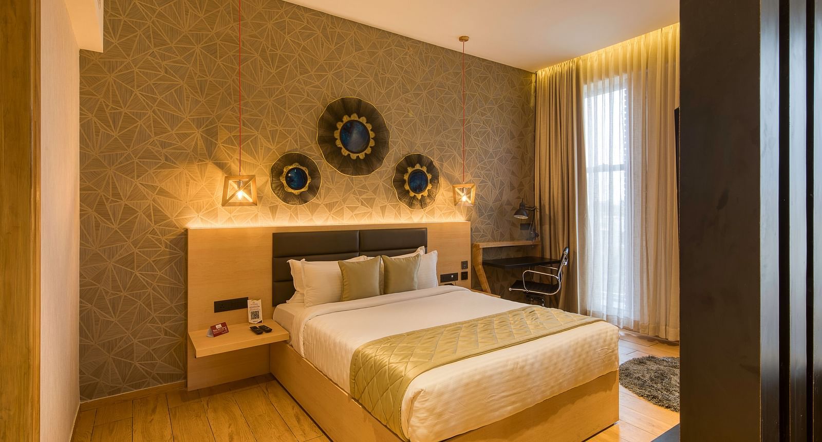 A double bed with golden bedsheets at Sumo Suite at Le Foliage by TGI, Bangalore