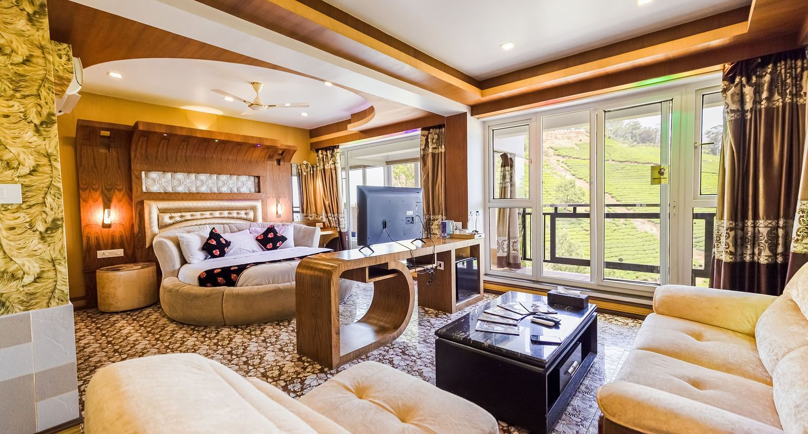 A living area and a round bed in the Honeymoon Suite at Parakkat Nature Hotel and Resorts Munnar 2