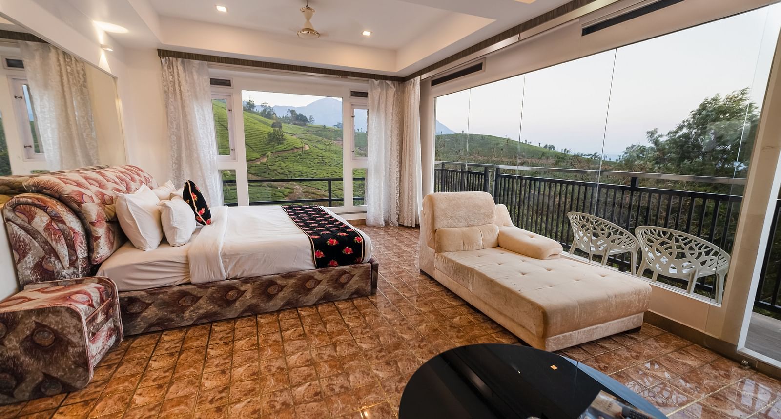 Side view of the bed and sofas at the Family Interconnected Club Suite Parakkat Nature Hotel and Resorts Munnar 1
