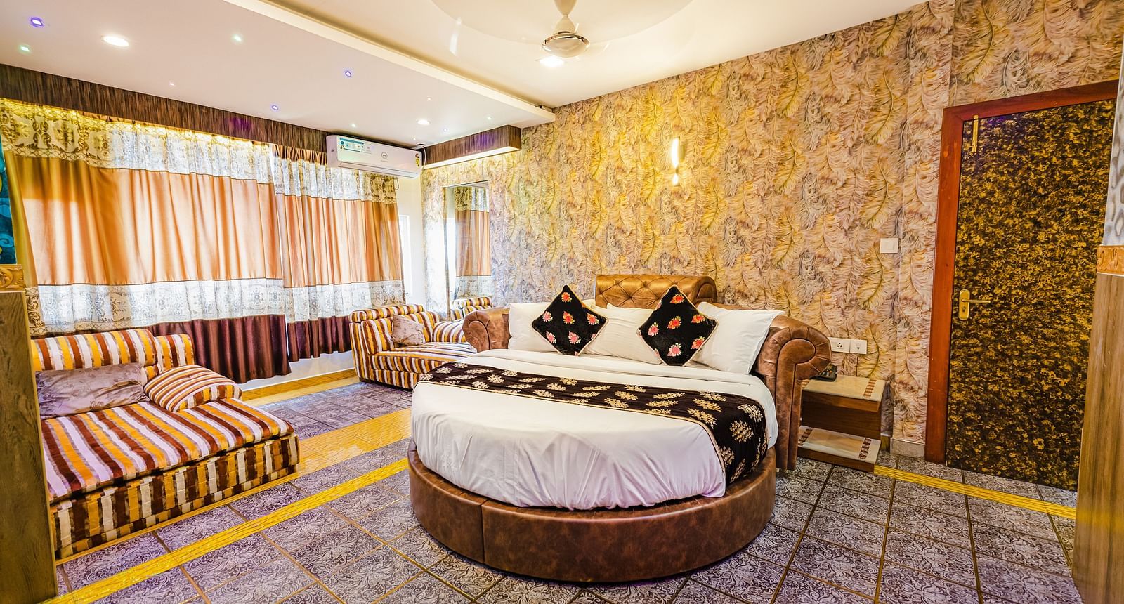 A round bed and sofa in the Jacuzzi Family Room at Parakkat Nature Hotel and Resorts Munnar 2