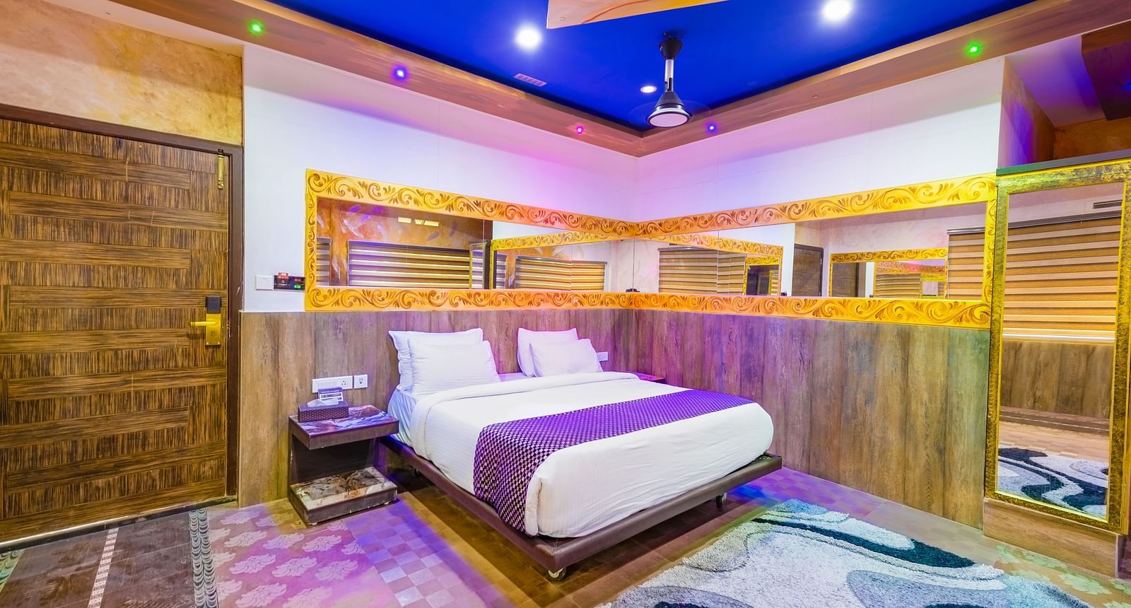 Side view of the double bed with blue ceiling in the Jungle Room at Parakkat Nature Hotel and Resorts Munnar 3