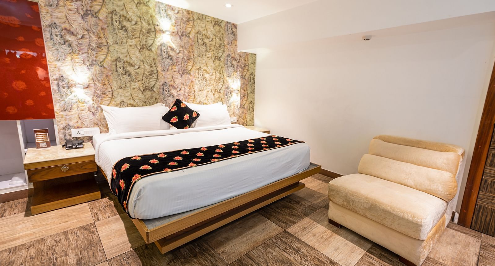 wide view of a double bed and a single sofa in the Premium Room at Parakkat Nature Hotel and Resorts Munnar 2
