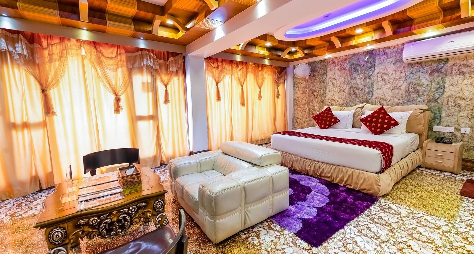 Living area and king size bed in the Presidential Suite at Parakkat Nature Hotel and Resorts Munnar 5
