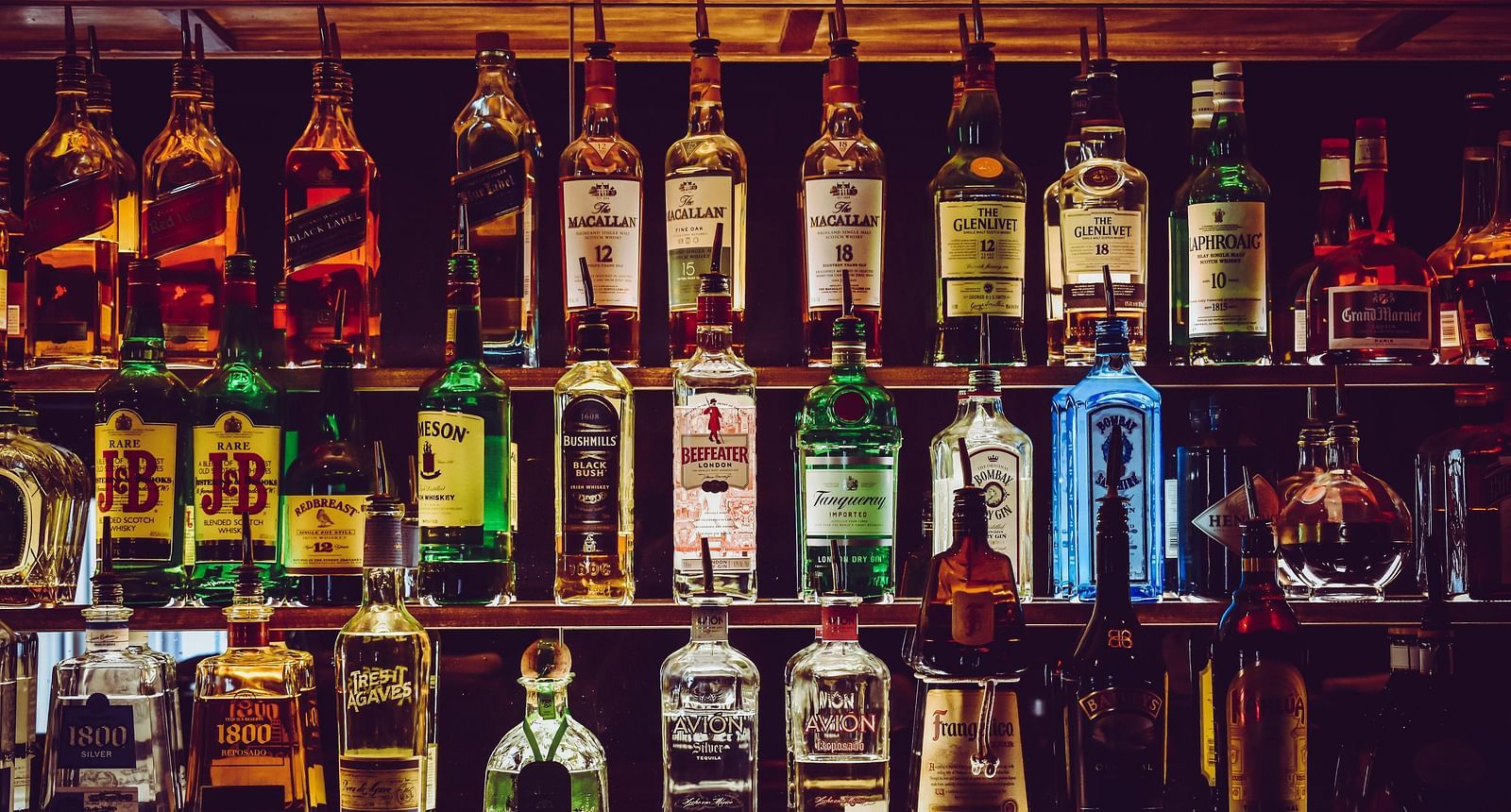 An assortment of wine bottles placed on the counter.