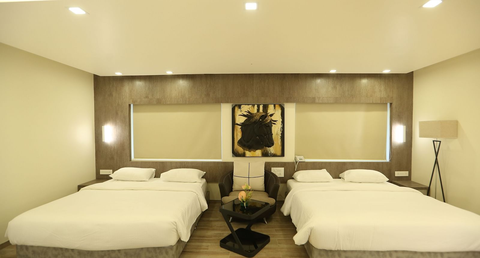 Club Suite with two double beds, and soft lighting.