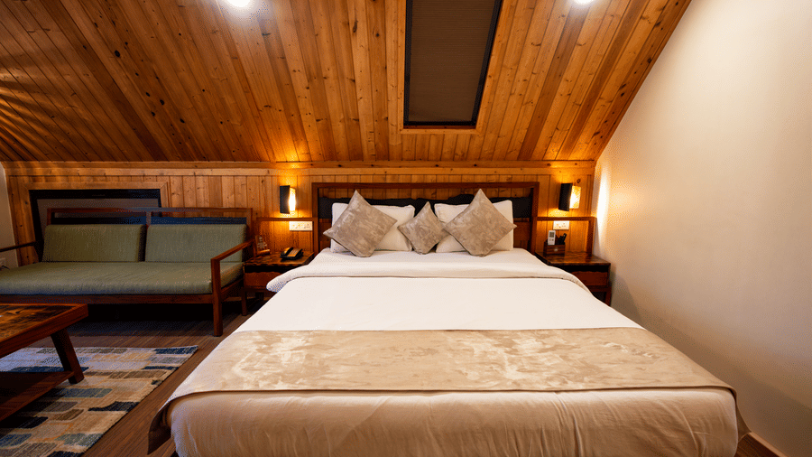 A large bed with a slanting roof at Hotel Sonar Bangla, Taki.