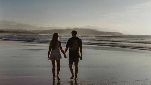 a couple walking on the beach
