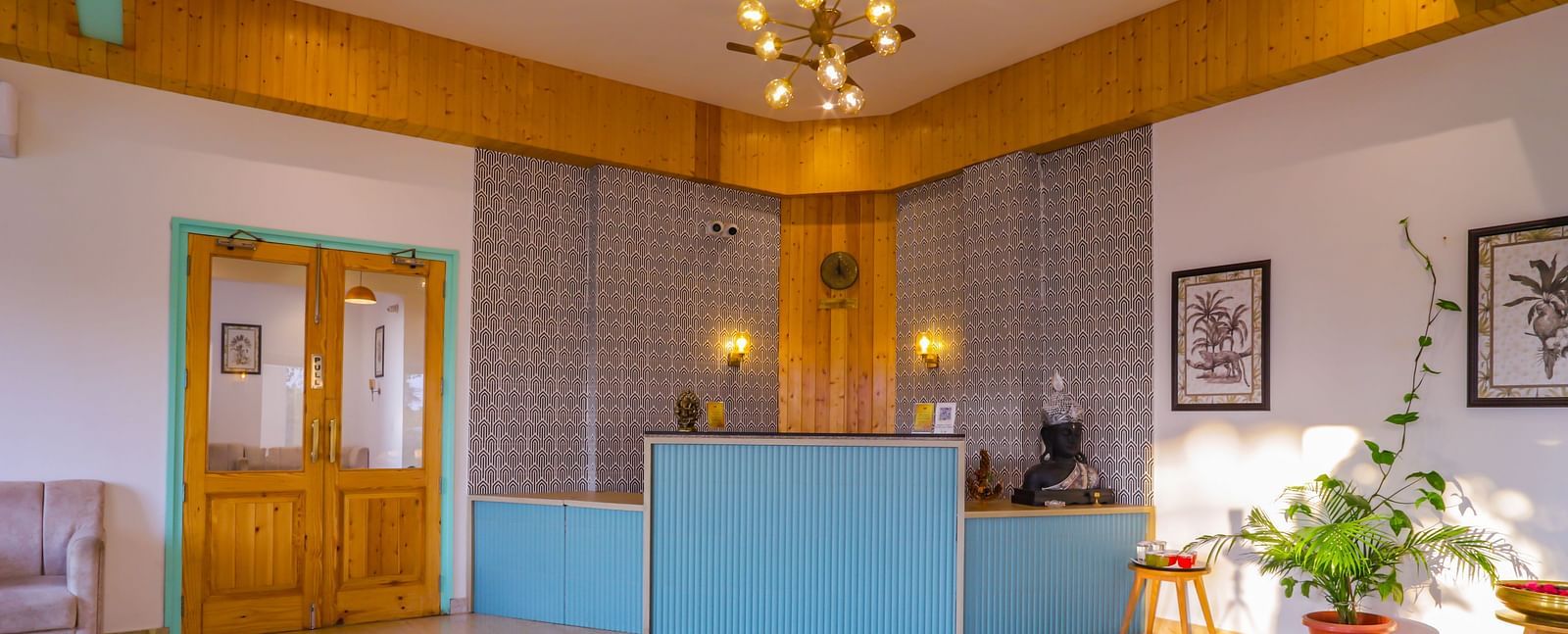 The reception area at Vedikant Resorts The Mallard Corbett has a blue counter and a bright, welcoming space.