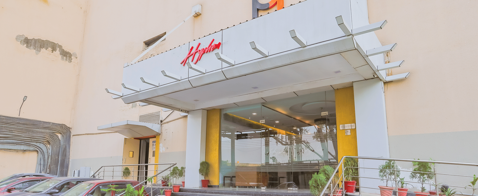 Facade entrance of Hyphen Premier Hotel, Meerut with many steps leading to the hotel building.
