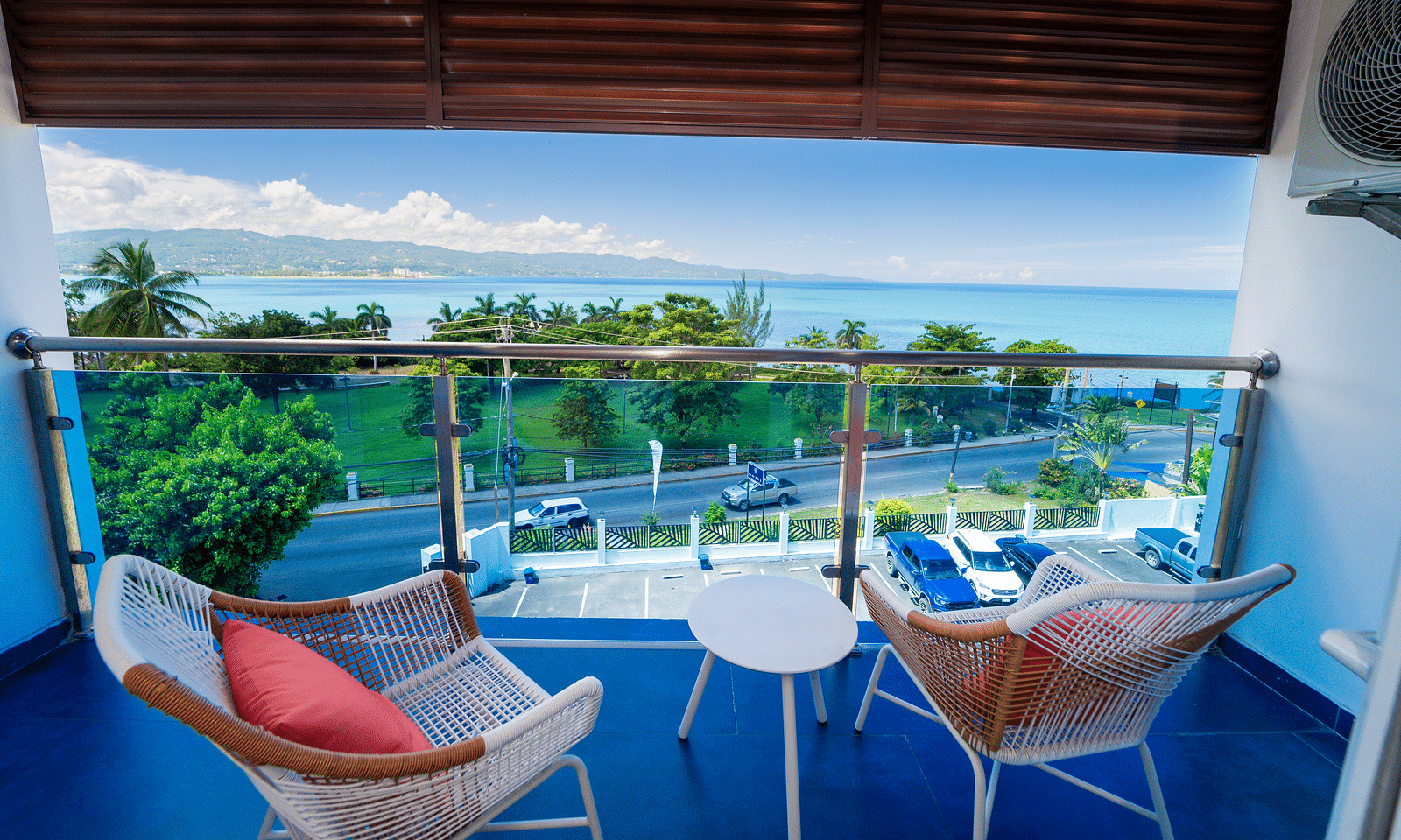 An image of a balcony in our Montego Bay hotel room that opens to the view of the coast of Montego Bay - Hotel 39, Jamaica (Montego Bay)