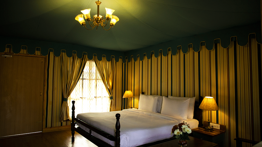 A white bed surrounded by walls with patterns of vertical lines