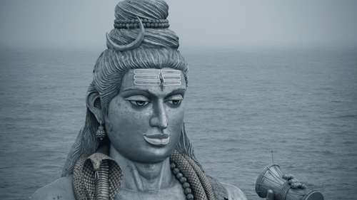 Statue of Lord Shiva with a water body in the background - Ramgarh Bungalows, Nainital.
