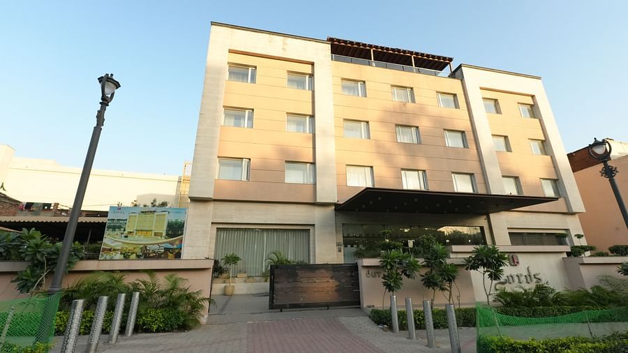 Hotel entrance with potted plants and signage - Grand Plaza Lords Inn Jammu