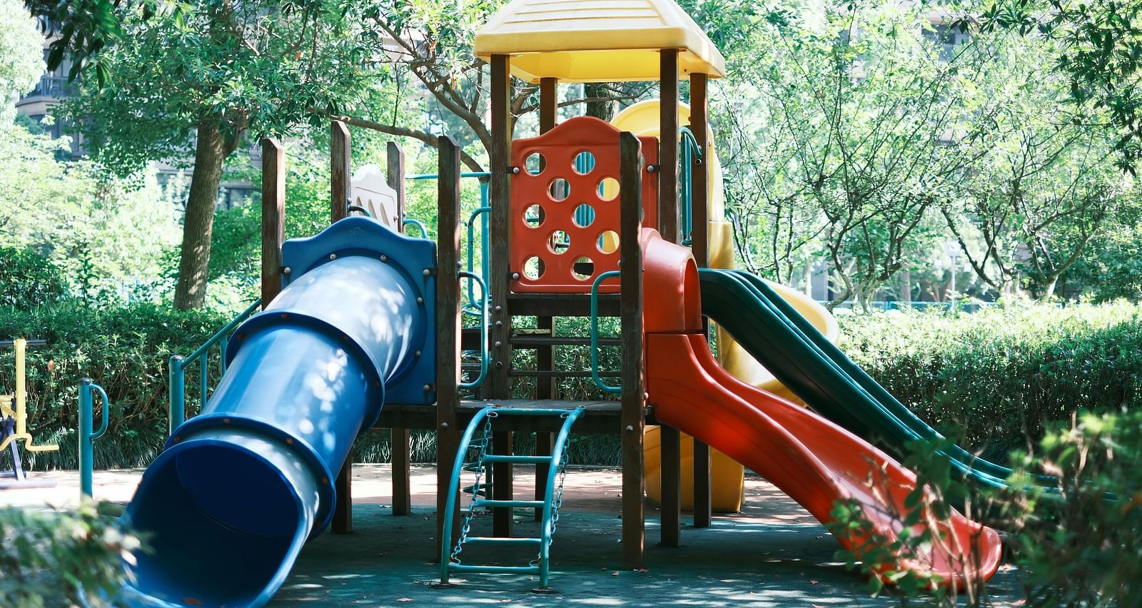 a kids slide along with a tunnel slide in a garden